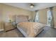 Guest bedroom with a tufted headboard and window views at 10073 S Yacht Club Dr, Treasure Island, FL 33706