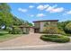 Two-story house featuring a stone facade and paved driveway at 10073 S Yacht Club Dr, Treasure Island, FL 33706