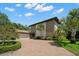 Two-story home with stone exterior and palm trees at 10073 S Yacht Club Dr, Treasure Island, FL 33706