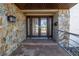 Double front doors with glass panels and stonework at 10073 S Yacht Club Dr, Treasure Island, FL 33706