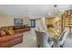 Spacious living room featuring a brown leather sectional and large artwork at 10073 S Yacht Club Dr, Treasure Island, FL 33706