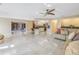Open living room and kitchen with tile floors and a ceiling fan at 10073 S Yacht Club Dr, Treasure Island, FL 33706