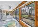 Spacious sunroom with glass doors opening to backyard at 10073 S Yacht Club Dr, Treasure Island, FL 33706