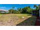 Spacious backyard with screened patio and mature trees at 1493 Eagle St, Port Charlotte, FL 33952