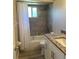 Updated bathroom with granite countertop, tile shower, and white vanity at 1493 Eagle St, Port Charlotte, FL 33952