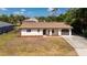 Single-story home with brown roof, landscaping, and driveway at 1493 Eagle St, Port Charlotte, FL 33952