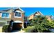 Townhouse exterior with landscaping and a two-car garage at 10254 Red Currant Ct, Riverview, FL 33578