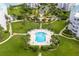 Aerial view of community pool and surrounding green space at 8001 Sailboat Key S Blvd # 204, St Pete Beach, FL 33707
