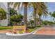 Attractive entrance to Coral Pointe community with palm trees and landscaping at 8001 Sailboat Key S Blvd # 204, St Pete Beach, FL 33707
