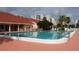 Inviting community pool with plenty of surrounding lounge chairs at 8001 Sailboat Key S Blvd # 204, St Pete Beach, FL 33707