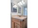 Clean bathroom with light wood cabinets and a large mirror at 6268 Palma Del Mar S Blvd # 406, St Petersburg, FL 33715