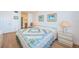 Bedroom with queen bed, dresser, and access to bathroom at 6268 Palma Del Mar S Blvd # 406, St Petersburg, FL 33715