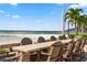 Beachfront patio with a large table and chairs at 830 S Gulfview Blvd # 102, Clearwater, FL 33767