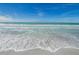 White waves rolling onto a sandy beach at 1460 Gulf Blvd # 1212, Clearwater Beach, FL 33767