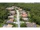 Aerial view of a luxury community with houses, pools, and lush greenery at 4995 Quill Ct, Palm Harbor, FL 34685