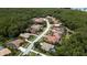 Aerial perspective of a residential neighborhood surrounded by trees at 4995 Quill Ct, Palm Harbor, FL 34685