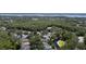 Aerial view of houses near a lake with lush green surroundings at 4995 Quill Ct, Palm Harbor, FL 34685