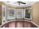 Bright Gathering room with hardwood floors, pool view, and plantation shutters at 4995 Quill Ct, Palm Harbor, FL 34685