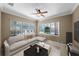 Relaxing living room featuring a sectional sofa and large windows at 4995 Quill Ct, Palm Harbor, FL 34685