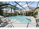 Inviting pool and spa with screened enclosure, perfect for relaxation at 4995 Quill Ct, Palm Harbor, FL 34685