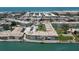 Beautiful aerial view of the community featuring a sparkling swimming pool and bocce ball court near ocean at 6201 2Nd E St # 73, St Pete Beach, FL 33706