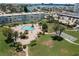 Wonderful aerial showcasing the community's pool, shuffleboard court and lush landscaping near the water at 6201 2Nd E St # 73, St Pete Beach, FL 33706