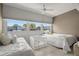 Bright bedroom featuring two beds, a large window, and a neutral color scheme at 6201 2Nd E St # 73, St Pete Beach, FL 33706