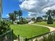 Landscaped community grounds with walkway, mature trees, and lush green lawn at 6201 2Nd E St # 73, St Pete Beach, FL 33706