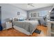 Bedroom with ceiling fan, window shutters, a queen bed, and wood-look flooring at 6201 2Nd E St # 73, St Pete Beach, FL 33706