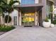 Modern building entrance with glass doors and landscaping at 100 1St N Ave # 2205, St Petersburg, FL 33701