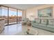 Relaxing living room featuring view of patio and comfortable seating at 1 Key Capri # 102E, Treasure Island, FL 33706