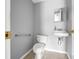 Clean bathroom with toilet, sink, and grab bar at 800 Pasadena S Ave, St Petersburg, FL 33707