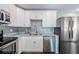 White cabinets and granite countertops in this updated kitchen at 2723 Sherbrooke Ln # B, Palm Harbor, FL 34684