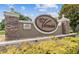 Entrance to The Verandahs, a deed restricted community, featuring stone pillars and manicured landscaping at 13856 Royston Bnd, Hudson, FL 34669