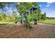 Community playground with modern climbing structures, slides, and benches in a landscaped setting at 13856 Royston Bnd, Hudson, FL 34669