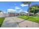 House exterior with gray siding, yellow door, and palm trees at 4031 Reggie Dr, Holiday, FL 34691