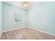 Charming bedroom with light walls and wood-look tile floors at 131 Pennsylvania Ave, Palm Harbor, FL 34683