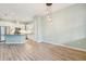 Bright dining room with light wood floors and stylish light fixture at 131 Pennsylvania Ave, Palm Harbor, FL 34683