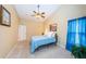 Serene bedroom with tile flooring, a ceiling fan, and blue accents at 3482 Rolling Trl, Palm Harbor, FL 34684