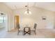 Cozy dining area with a glass table set, tile floors, and ample natural light at 3482 Rolling Trl, Palm Harbor, FL 34684