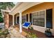 Inviting front porch with a cozy blue bench and tasteful landscaping, creating a welcoming entry at 3482 Rolling Trl, Palm Harbor, FL 34684