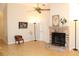 Living room with a brick fireplace, ceiling fan, and bright natural light at 3482 Rolling Trl, Palm Harbor, FL 34684