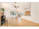 Bright and airy living room with a ceiling fan, fireplace, and sliding glass doors to the outdoor patio at 3482 Rolling Trl, Palm Harbor, FL 34684