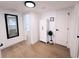 Bright hallway with wood floors, white doors, and a tall white cabinet at 811 40Th S Ave, St Petersburg, FL 33705