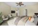 Spacious bedroom with plush bedding and two seating chairs at 1733 Split Fork Dr, Oldsmar, FL 34677