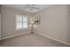 Bright bedroom featuring plantation shutters and wall art at 1733 Split Fork Dr, Oldsmar, FL 34677