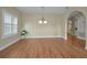 Spacious dining room featuring hardwood floors and a light fixture at 1733 Split Fork Dr, Oldsmar, FL 34677