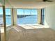 Bright living room featuring wall-to-wall windows with water views at 100 Pierce St # 703, Clearwater, FL 33756
