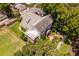 Two-story home with gray roof and screened porch, nestled among trees at 716 14Th Ne Ave, St Petersburg, FL 33701