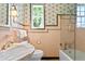 Stylish bathroom with pink tile, marble accents, and a glass shower at 716 14Th Ne Ave, St Petersburg, FL 33701